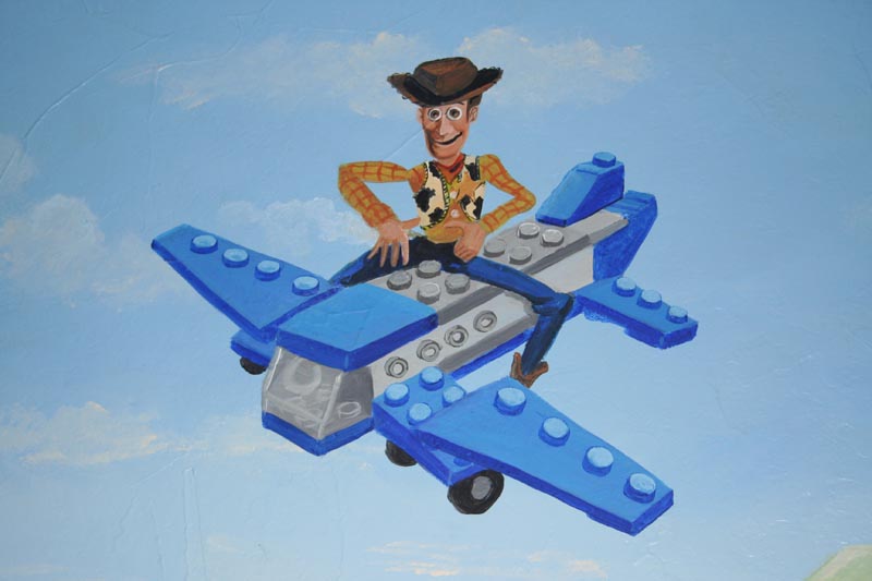 Woody takes a ride on a Lego plane